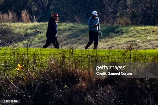 President Donald Trump waves as he plays golf at his club, Trump National Golf Club, on November 14, 2020 in Sterling, Virginia. The President is...