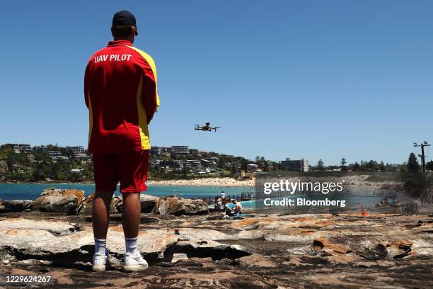 Surf Life Saving NSW UAV Pilot Finley Stone operates a Mavic 2 Enterprise Drone to observe beachgoers on Freshwater Beach in Sydney, Australia, on...