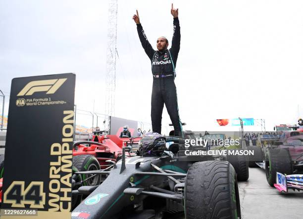 Mercedes' British driver Lewis Hamilton reacts as he gets out of his car after winning the Turkish Formula One Grand Prix at the Intercity Istanbul...