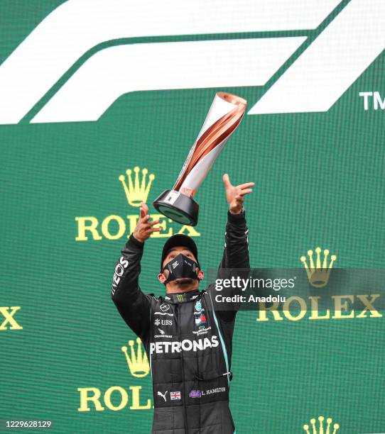 First Place winner British driver Lewis Hamilton of Mercedes celebrates on the podium after placing first in the Formula 1 DHL Turkish Grand Prix...