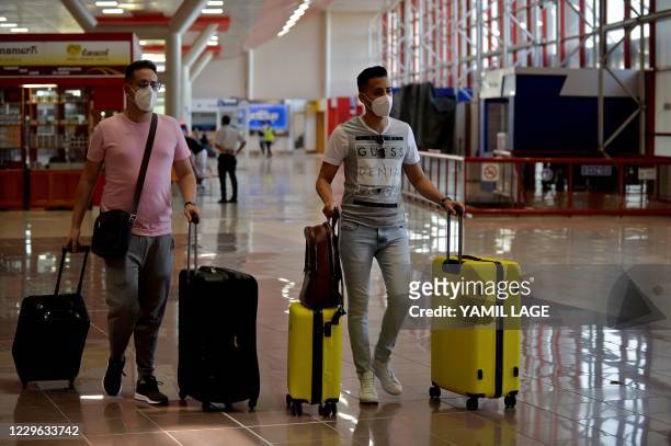 Passengers arrive at the Jose Marti International Airport as commercial flights resume in Havana on November 15 after almost eight months amid the...