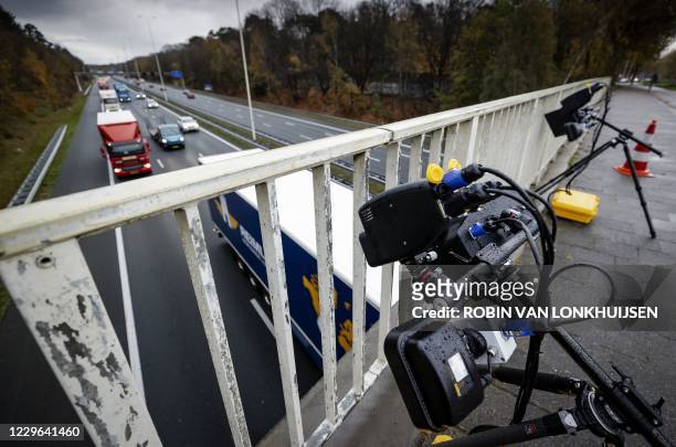 Smart cameras are set up along the A28 in Zeist, on November 16 to detect motorists holding a phone, who are automatically registered and...