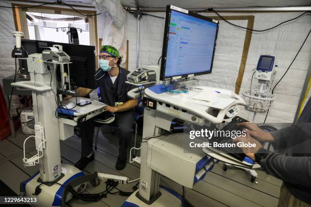 Emergency Medicine MD Christian Klaucke, left, and RN Benjamin Romano, work out of a temporary tent set up aat UMass Memorial Hospital in Worcester,...