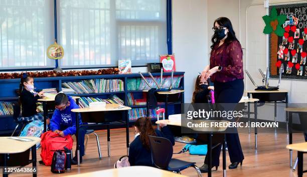 First grade instructor Laura Sanchez speaks to her returning students at St. Joseph Catholic School in La Puente, California on November 16 where...