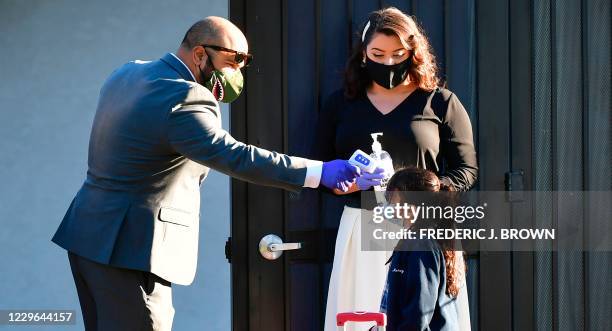 Temperature check is taken as students return to St. Joseph Catholic School in La Puente, California on November 16 where pre-kindergarten to Second...