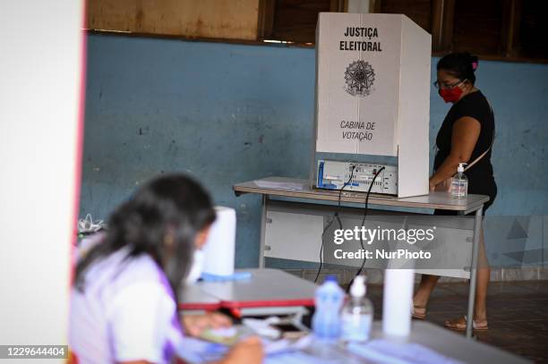 Woman arrives to vote at a polling booth during municipal elections amid the Coronavirus pandemic in Santana, Amapá State, Brazil, on November 15,...