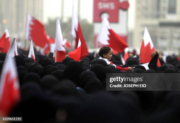 Bahraini Shiite anti-government protesters take part in a rally in remembrance of the seven people who were killed in police crackdowns as they march...