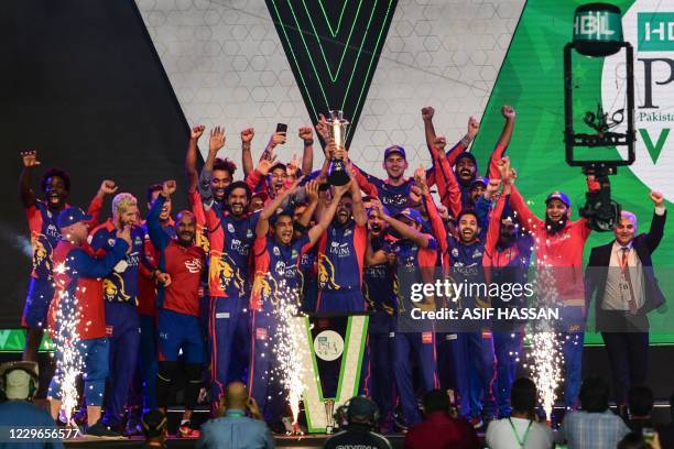 Karachi Kings' cricketers celebrate with the trophy after winning the Pakistan Super League Twenty20 cricket final match between the Karachi Kings...