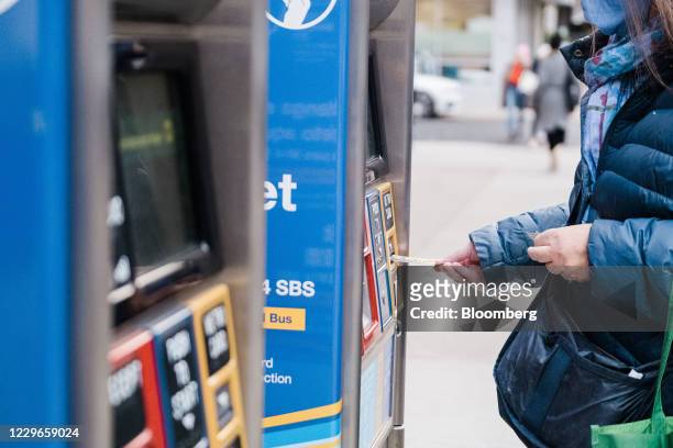 Commuter inserts a Metropolitan Transportation Authority card into a kiosk in New York, U.S., on Tuesday, Nov. 17, 2020. New York's Metropolitan...