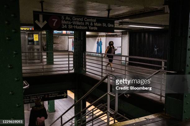 Commuter walks through the Times Square subway station in New York, U.S., on Tuesday, Nov. 17, 2020. New York's Metropolitan Transportation Authority...