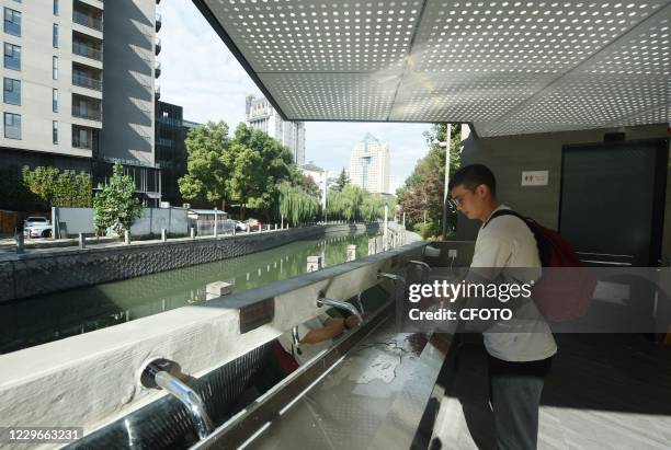 Citizen washes his hands using an automatic sensor tap in a public toilet in Hangzhou, Zhejiang province, China, on November 18, 2020.