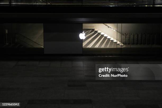 The Apple logo is seen at Apple Store near Piazza Duomo in Milan at night during the lockdown period due to the coronavirus emergency, Italy, on...