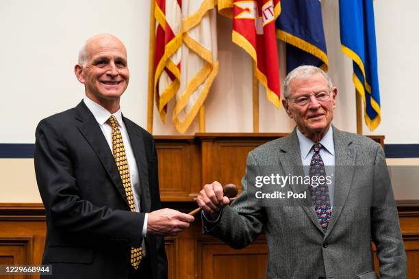 Leaders of the House and Senate Armed Services Committees U.S. Rep. Adam Smith and Sen. James Inhofe participate in a ceremonial gavel passing in the...