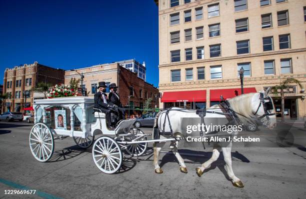 The Visual Artists Guild holds a horse-drawn hearse carraige caravan funeral procession in memory of the victims of COVID-19 down Colorado Blvd...