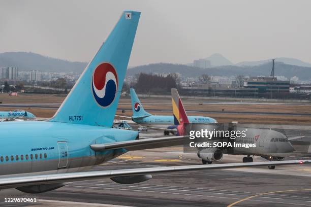 Planes of Korean Air and Asiana Airlines are seen at Gimpo International Airport in Seoul. Korean Air to buy Asiana Airlines. If the merger goes...