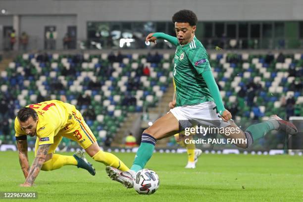 Northern Ireland's defender Jamal Lewis vies with Romania's defender Vasile Mogos during the UEFA Nations League group b1 football match between...