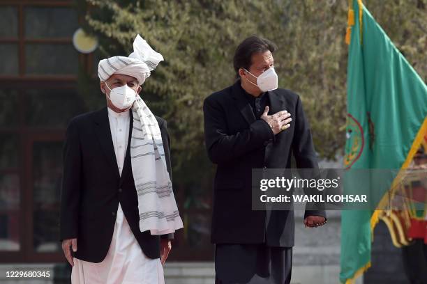 Pakistan's Prime Minister Imran Khan and Afghan President Ashraf Ghani inspect a guard of honour ahead of their joint press conference at the...