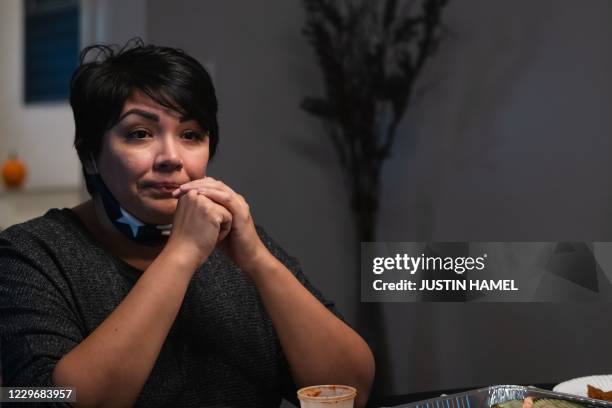 Erica Salas-Zavala pauses for a moment when talking about her father in law, Tomas P Zavala, who passed away from ovid-19 two nights ago at...