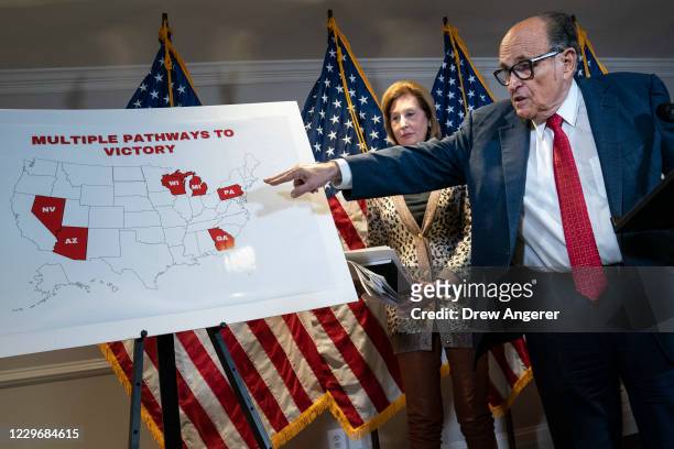 Rudy Giuliani points to a map as he speaks to the press about various lawsuits related to the 2020 election, inside the Republican National Committee...