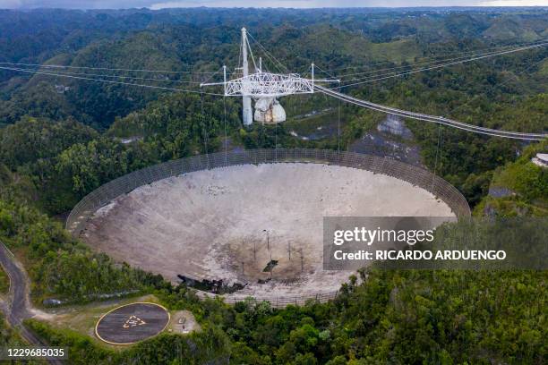 This aerial view shows a hole in the dish panels of the Arecibo Observatory in Arecibo, Puerto Rico, on November 19, 2020. - The National Science...
