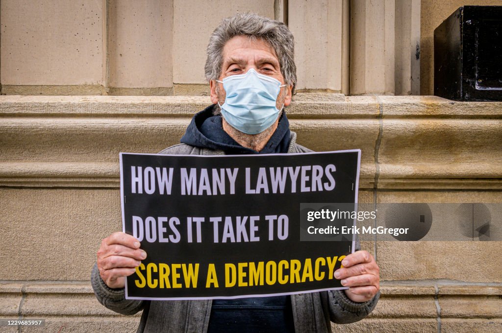 A participant seen holding a sign at the protest. Members of...