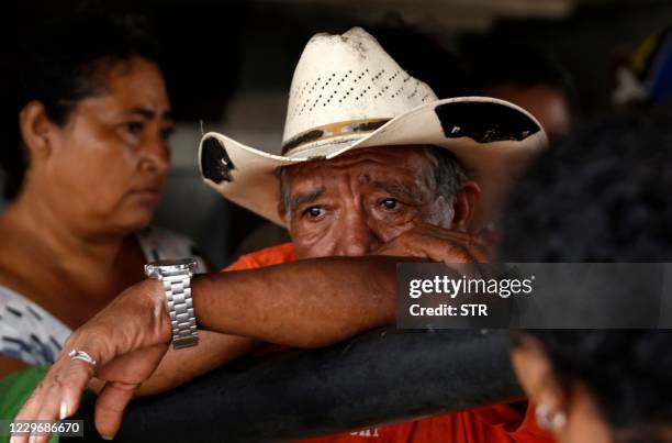 Man reacts under La Democracia bridge after being rescued by navy members from floods caused by the passage of Hurricane Iota in El Progreso, Yoro...