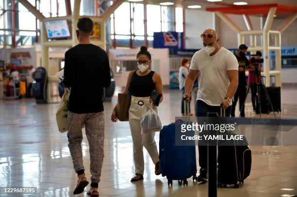 Passengers arrive at the Jose Marti International Airport in Havana, on November 15, 2020. - Havana is reopening its doors to foreign tourists, after...