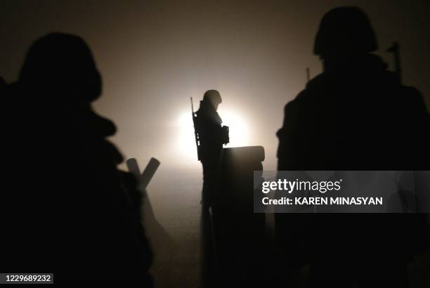 Armenian soldiers patrol at the check point outside Agdam to let last vehicles leave the region late on November 19, 2020 as the territory is due to...