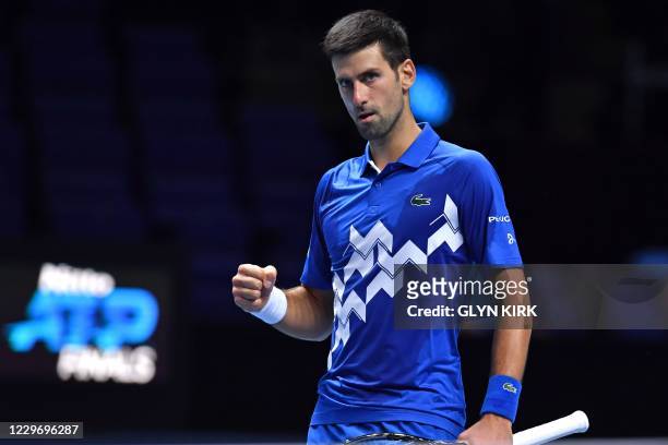Serbia's Novak Djokovic reacts as he beats Germany's Alexander Zverev in straight sets in their men's singles round-robin match on day six of the ATP...