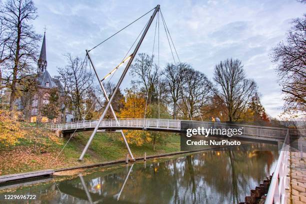 Pedestrian bridge in Utrecht. Daily life in Utrecht, the fourth largest Dutch city with the ancient city in the centre and the largest university in...