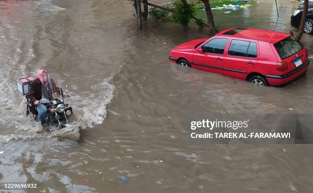 Man makes his way through a flooded street due to heavy rain in the Egyptian coastal city of Alexandria on November 20, 2020.