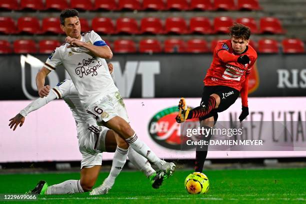 Rennes' French forward Adrien Hunou fights for the ball with Bordeaux's French defender Laurent Koscielny during the French L1 football match between...