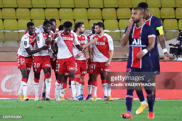 Monaco's Spanish midfielder Cesc Fabregas celebrates with teammates after scoring a penalty kick during the French L1 football match between Monaco...