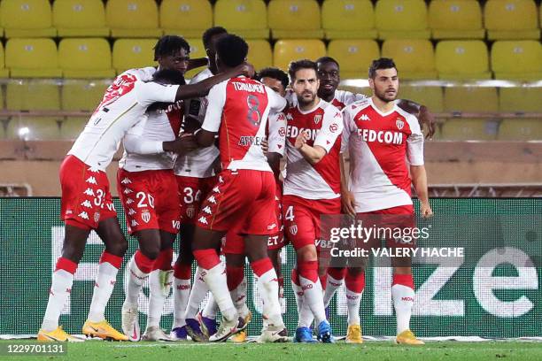 Monaco's Spanish midfielder Cesc Fabregas celebrates with teammates after scoring a penalty kick during the French L1 football match between Monaco...