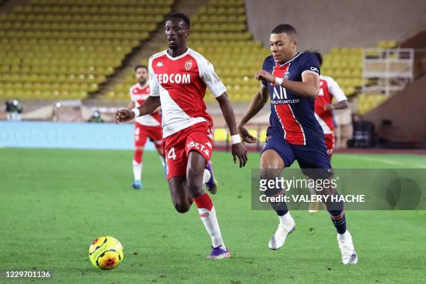 Monaco's French defender Chrislain Matsima vies for the ball with Paris Saint-Germain's French forward Kylian Mbappe during the French L1 football...