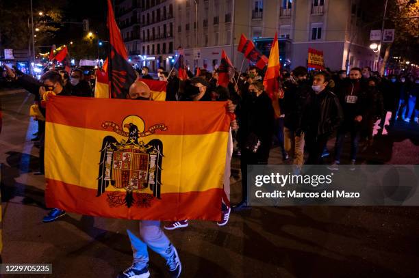 Far right wing supporter carrying a pre-constitutional Spanish flag during a rally to commemorate the death anniversary of Falange founder Jose...