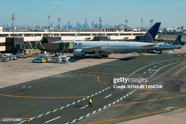 Airplanes are parked at their gates at Newark International Airport on November 21, 2020 in Newark, New Jersey. - Current US numbers -- more than a...