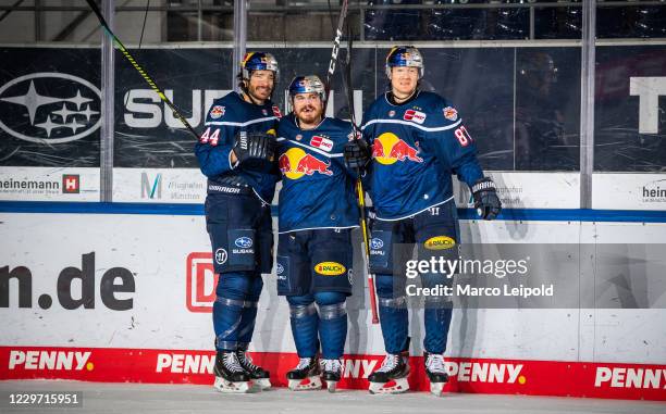 Zach Redmond, Chris Bourque and Philip Gogulla of EHC Red Bull Muenchen celebrate the 3:2 win after the Magenta Sport Cup match between EHC Red Bull...
