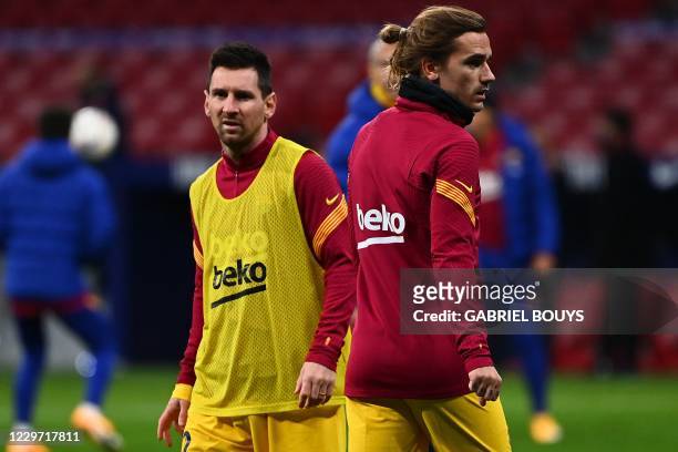 Barcelona's French midfielder Antoine Griezmann and Barcelona's Argentine forward Lionel Messi warm up before the Spanish League football match...