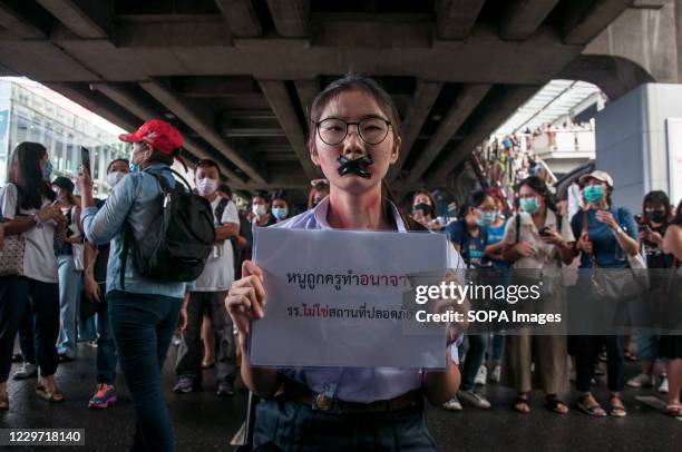 Student activist with tape on her mouth holds a placard that says "I was indecent by the teacher. School is not a safe place" during the...