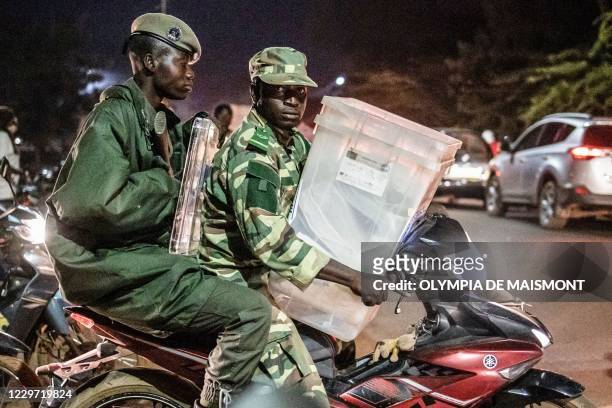 Security force leave a city hall where Independent National Electoral Commission distributes electoral material to polling station directors and...