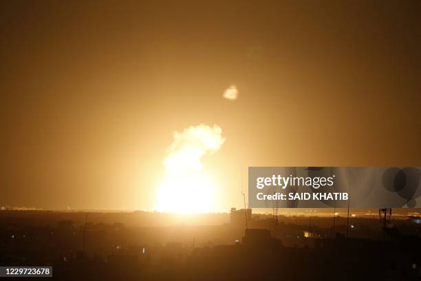 Flames are seen following an Israeli air strike in the town of Khan Yunis, in the southern Gaza Strip, early on November 22, 2020. - A rocket was...