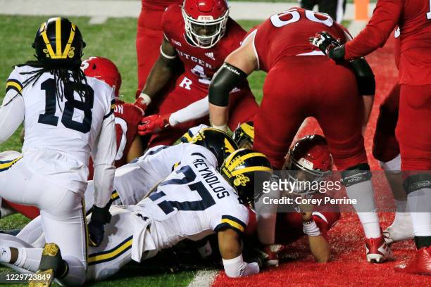 Noah Vedral of the Rutgers Scarlet Knights scores a two-point conversion during the fourth quarter against the Michigan Wolverines at SHI Stadium on...