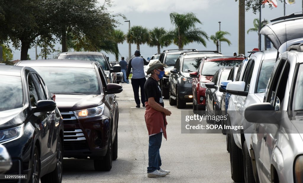 Volunteers direct traffic as residents line up in their cars...