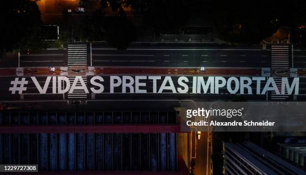 An aerial view of Paulista Avenue painted with the words #Vidas Pretas Importam as protests erupt against racism on November 22, 2020 in Sao Paulo,...