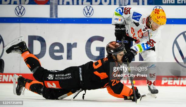 Jordan Boucher of the Grizzlys Wolfsburg and Mike Moore of the Fischtown Pinguins during the game between the Grizzlys Wolfsburg against the...