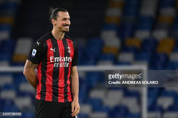 Milan's Swedish forward Zlatan Ibrahimovic, with red marks on his face as part of a campaign to stop domestic violence against women, reacts prior to...