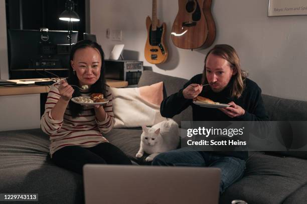 Couple celebrates Thanksgiving with friends by having dinner together over a Zoom video call on November 22, 2020 in New York City. As new COVID-19...