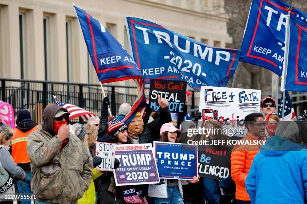 Supporters of US President Donald Trump gather to make their opinion heard outside the Michigan State Capital as Michigan's Board of State Canvassers...