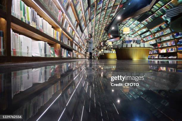 Reader reads books at zhongshuge store in Yangzhou, East China's Jiangsu Province, Nov. 24, 2020.-